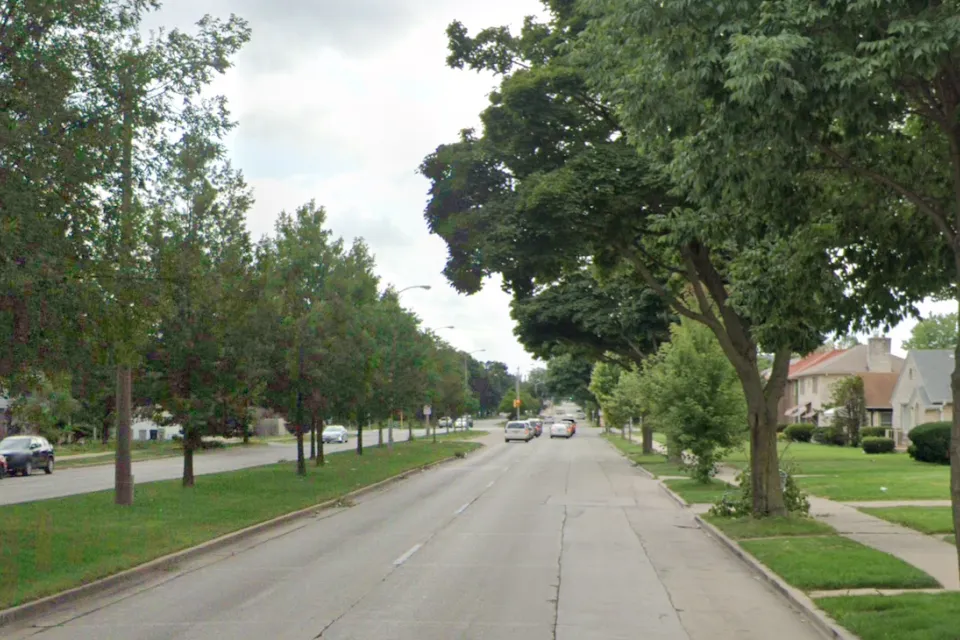 Street view of Sherman Blvd in Milwaukee, Wisconsin with landscaped median in middle of four-lane road.
